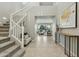 Spacious two-story foyer with staircase, tile floors, and views into the living room and backyard at 8516 W Peppertree Ln, Glendale, AZ 85305
