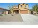Two story home featuring low maintenance desert landscaping, concrete driveway, and a 2 car garage at 8516 W Peppertree Ln, Glendale, AZ 85305