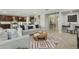 Open concept living room adjacent to the kitchen and dining area with modern decor and ample seating at 8516 W Peppertree Ln, Glendale, AZ 85305