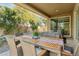 Relaxing covered patio with an outdoor dining table and chairs, perfect for entertaining guests at 8516 W Peppertree Ln, Glendale, AZ 85305