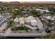 Expansive aerial view of a luxurious estate with a well-manicured lawn, tennis court and pool at 9128 N 70Th St, Paradise Valley, AZ 85253