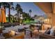 Inviting covered patio with comfortable seating and view of the pool, spa, and lush landscaping at 9128 N 70Th St, Paradise Valley, AZ 85253