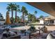 Luxurious backyard with a large pool, palm trees, comfortable seating and a manicured lawn at 9128 N 70Th St, Paradise Valley, AZ 85253