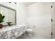 Stylish bathroom features a marble vanity, white subway tiles, and patterned tile flooring at 9128 N 70Th St, Paradise Valley, AZ 85253