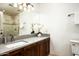 Bright bathroom with a vanity, quartz countertops, modern sink, decorative orchids and a walk-in shower at 9128 N 70Th St, Paradise Valley, AZ 85253