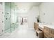 Bright bathroom offers a glass enclosed shower, soaking tub, and dual vanity with ample storage at 9128 N 70Th St, Paradise Valley, AZ 85253