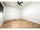 Unfurnished bedroom with light wood floors, a ceiling fan, and a window with shutters at 9128 N 70Th St, Paradise Valley, AZ 85253