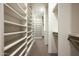 Spacious walk-in closet offers ample storage space with custom shelving and drawers at 9128 N 70Th St, Paradise Valley, AZ 85253
