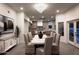 Open concept dining room boasts modern light fixture, seating for eight and a view to living and dining spaces at 9128 N 70Th St, Paradise Valley, AZ 85253