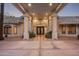 Elegant home entrance with unique double doors, tile roof, covered portico and column supports at 9128 N 70Th St, Paradise Valley, AZ 85253
