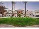 Elegant home featuring manicured lawn, palm trees, and a circular driveway leading to a covered entrance at 9128 N 70Th St, Paradise Valley, AZ 85253