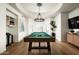 Game room boasts a pool table, hardwood flooring, tray ceilings, and built-in shelving at 9128 N 70Th St, Paradise Valley, AZ 85253