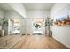 Inviting hallway featuring hardwood floors, backyard access, a large mirror, and an art piece at 9128 N 70Th St, Paradise Valley, AZ 85253