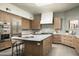 Well-appointed kitchen with modern appliances, stylish cabinetry, and a center island with bar seating at 9128 N 70Th St, Paradise Valley, AZ 85253