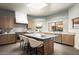 Modern kitchen features an island with seating, stainless steel appliances, and marble countertops at 9128 N 70Th St, Paradise Valley, AZ 85253