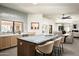 Open concept kitchen with gray backsplash, large kitchen island with bar seating, and view to dining and living spaces at 9128 N 70Th St, Paradise Valley, AZ 85253