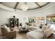 Beautifully decorated living room featuring a unique ceiling design, designer furnishing, and backyard views at 9128 N 70Th St, Paradise Valley, AZ 85253