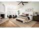 Spacious main bedroom with fireplace features hardwood floors, accent seating, and natural light at 9128 N 70Th St, Paradise Valley, AZ 85253