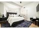 Spacious main bedroom featuring a tufted headboard, stylish nightstands, and shuttered windows for natural light at 9128 N 70Th St, Paradise Valley, AZ 85253