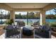 Covered outdoor living space with comfortable seating overlooking a tennis court at 9128 N 70Th St, Paradise Valley, AZ 85253