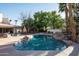 Backyard pool and patio with outdoor seating and lush tropical landscaping at 9128 N 70Th St, Paradise Valley, AZ 85253