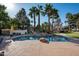 Backyard pool with rock waterfall feature, putting green, sports court, and covered outdoor living area at 9128 N 70Th St, Paradise Valley, AZ 85253