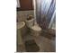 Bathroom featuring tile flooring, a pedestal sink, and bathtub-shower combo at 914 W Sahuaro Dr, Phoenix, AZ 85029