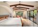 Spacious main bedroom with wood beams, natural light and beautiful outdoor views at 10002 E Adele Ct, Scottsdale, AZ 85255