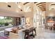 Bright living room with high ceilings, wood beams, and seamless indoor-outdoor living by the pool at 10002 E Adele Ct, Scottsdale, AZ 85255