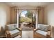 Serene patio view framed by an arched doorway in a cozy seating area at 10002 E Adele Ct, Scottsdale, AZ 85255