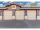 A well-maintained multiple-car garage exterior with neutral doors and coordinated trim at 10136 E Southern Ave # 2062, Mesa, AZ 85209