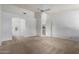 Neutral carpeted bedroom with white walls, ceiling fan, and en suite bathroom with double doors at 11065 W Runion Dr, Peoria, AZ 85373