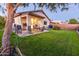 Well-maintained backyard with a covered patio and lawn perfect for relaxing and entertaining at 11197 W Coronado Rd, Avondale, AZ 85392