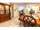 Dining room featuring wooden table and chairs, tiled flooring, and an archway leading to the living room at 11197 W Coronado Rd, Avondale, AZ 85392