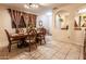 Bright dining area with a wooden table and chairs, tiled flooring, and decorative archway to the living room at 11197 W Coronado Rd, Avondale, AZ 85392