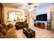 Comfortable living room featuring tiled floors, neutral walls, and a partial view of the adjacent dining area at 11197 W Coronado Rd, Avondale, AZ 85392