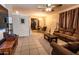 Cozy living room with comfortable seating, tiled flooring, and a view of the dining area through an archway at 11197 W Coronado Rd, Avondale, AZ 85392