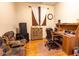 Well-lit office space features a wooden desk, comfortable chair, and storage, perfect for a home workspace at 11197 W Coronado Rd, Avondale, AZ 85392