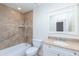 Tiled bathroom with a combined bath and shower, granite countertop and white cabinet, toilet, and a large mirror at 12224 N Gambel Dr, Fountain Hills, AZ 85268