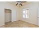 Cozy bedroom with tile floors, a ceiling fan, a window with shutters, and a closet with sliding doors at 12224 N Gambel Dr, Fountain Hills, AZ 85268