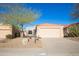 Charming single-story home with a tile roof, desert landscaping, and a two-car garage against a clear blue sky at 12224 N Gambel Dr, Fountain Hills, AZ 85268
