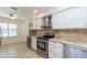 Bright kitchen featuring stainless steel appliances, granite countertops, and white cabinets at 12224 N Gambel Dr, Fountain Hills, AZ 85268
