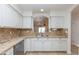 Kitchen boasts granite counters, white cabinets, and stainless steel sink at 12224 N Gambel Dr, Fountain Hills, AZ 85268