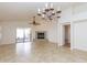 Open living area with tile floors, fireplace, sliding glass doors to backyard, and ceiling fan at 12224 N Gambel Dr, Fountain Hills, AZ 85268