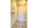 Interior laundry room with tile flooring and storage cabinet at 12429 N 111Th Dr, Youngtown, AZ 85363