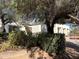 View of the front entrance of the home from behind some of the landscaping at 12808 W San Miguel Rd, Litchfield Park, AZ 85340