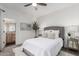 Bright bedroom with a neutral color scheme, plush carpet, decorative pillows, and an ensuite bathroom entrance at 1411 E Orangewood Ave # 202, Phoenix, AZ 85020