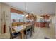 Open dining area with glass table, seating for six, and direct view into the gourmet kitchen at 15305 S 180Th Ave, Goodyear, AZ 85338