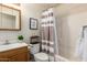 Bathroom featuring a tub, shower and classic wood vanity with ample storage at 16350 N Desert Sage St, Surprise, AZ 85378