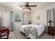 Bedroom featuring a ceiling fan, closet, large window, and natural light at 16350 N Desert Sage St, Surprise, AZ 85378